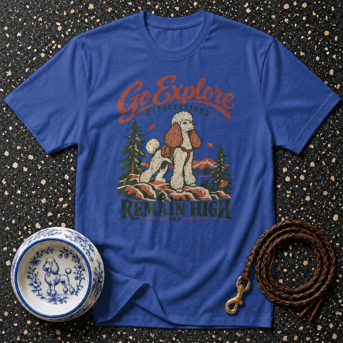 Blue t-shirt with a poodle graphic, mountains, trees, and text "Go Explore Remain High".