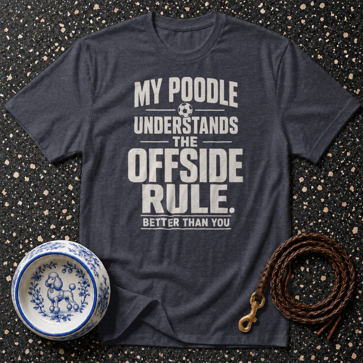 Dark grey t-shirt with text "My poodle understands the offside rule. Better than you." with a soccer ball graphic.