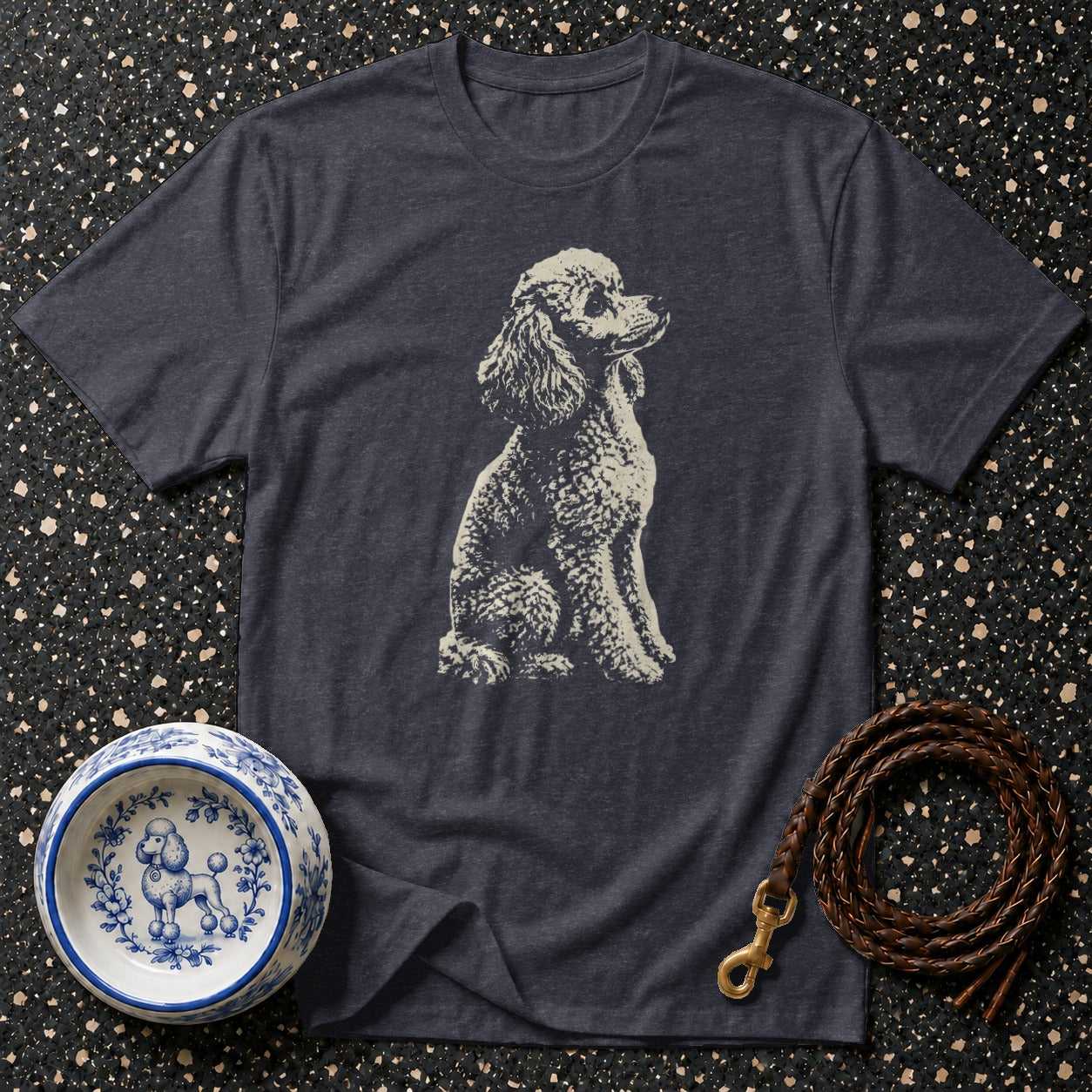 Dark grey t-shirt with a cream poodle graphic, blue and white poodle bowl, and leather leash.