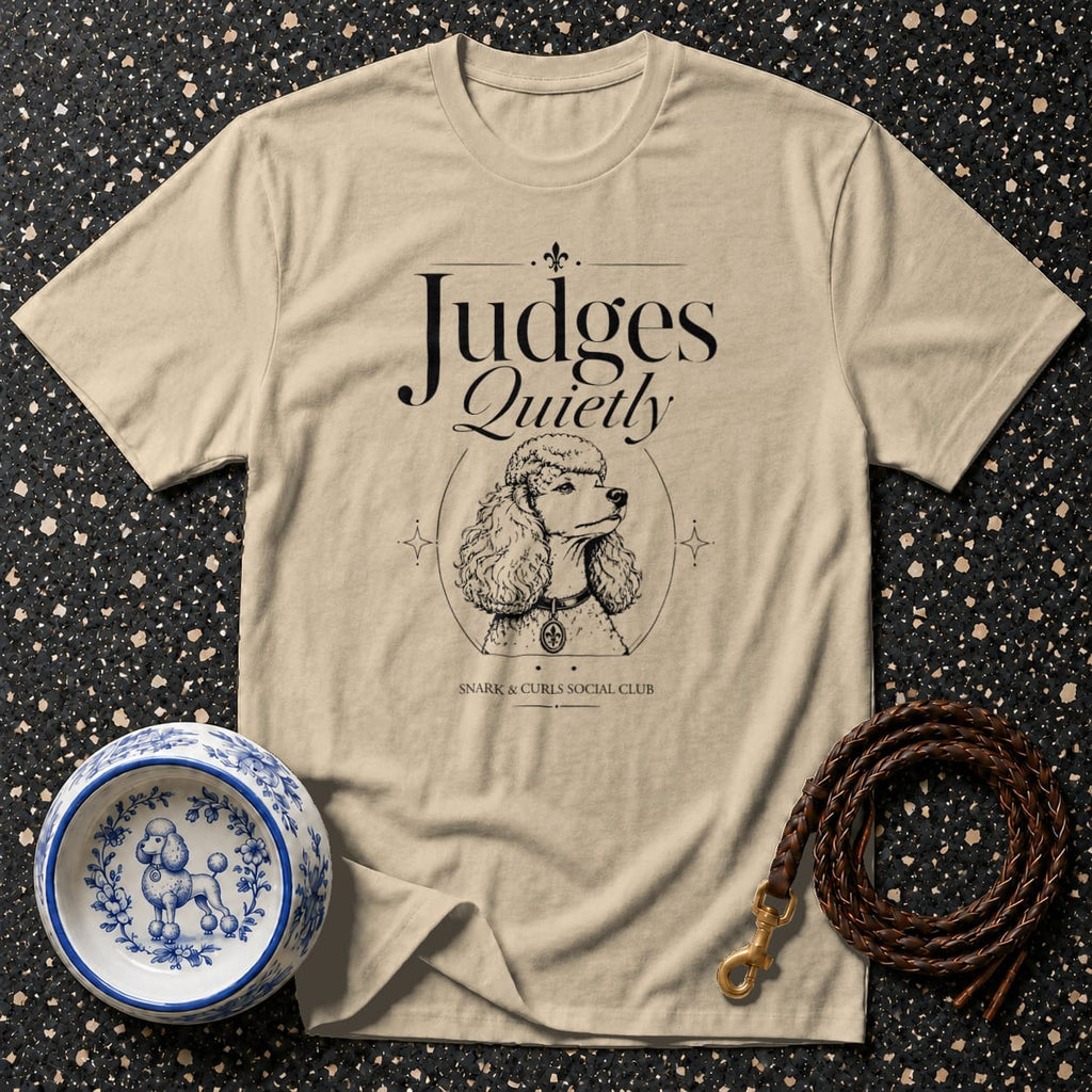 Beige t-shirt with a poodle illustration and text "Judges Quietly".