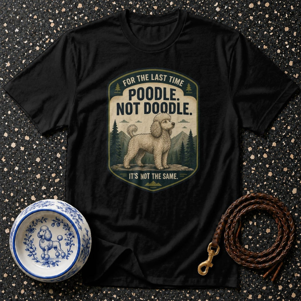 Black t-shirt with "Poodle. Not Doodle." and a poodle illustration.