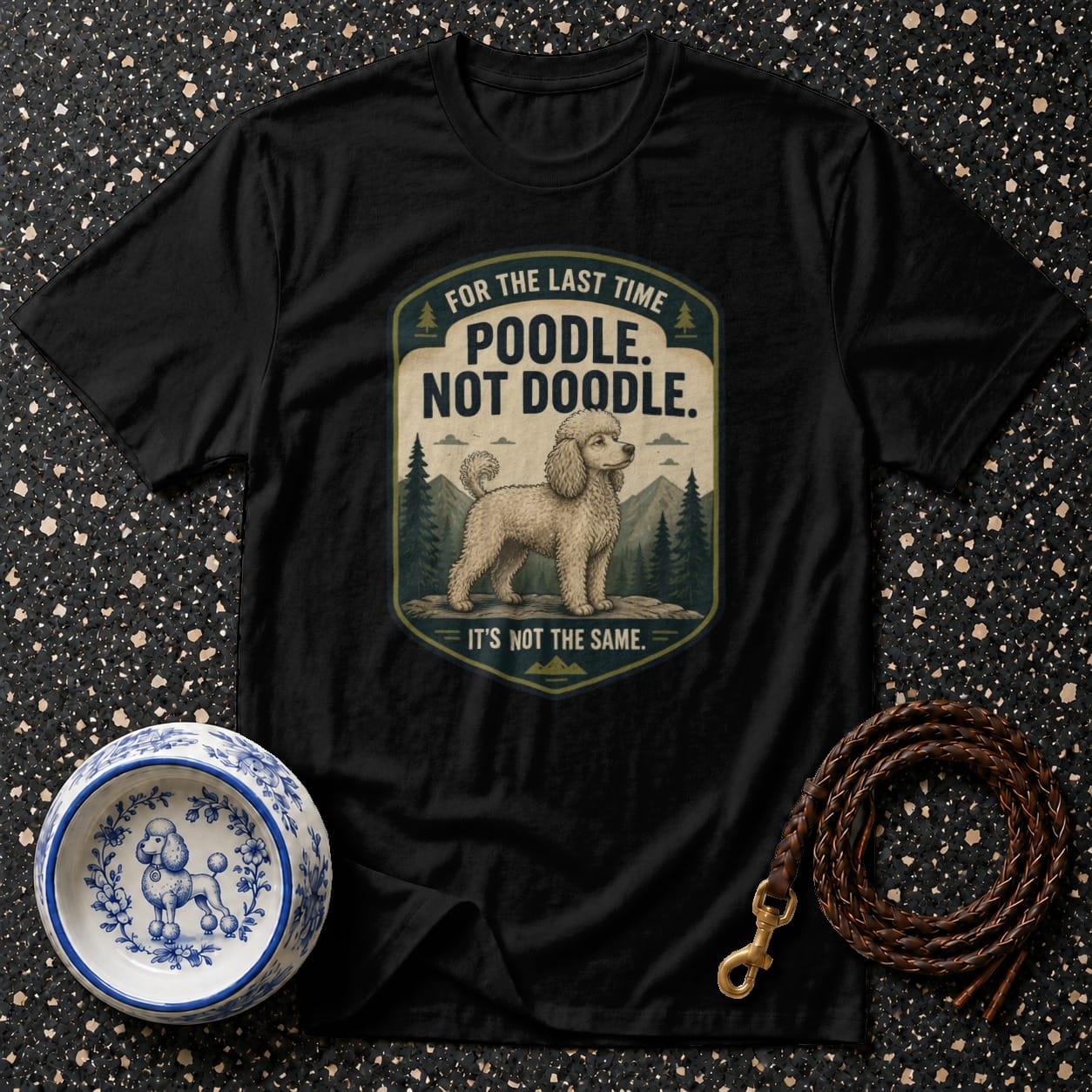 Black t-shirt with "Poodle. Not Doodle." and a poodle illustration.