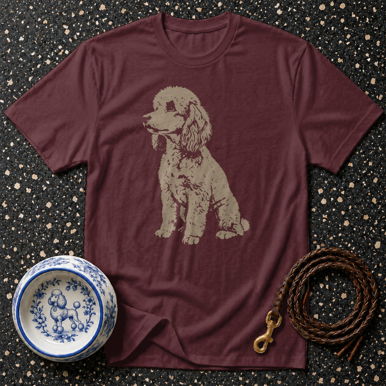 Maroon t-shirt with a tan poodle graphic, dog bowl, and leather leash.