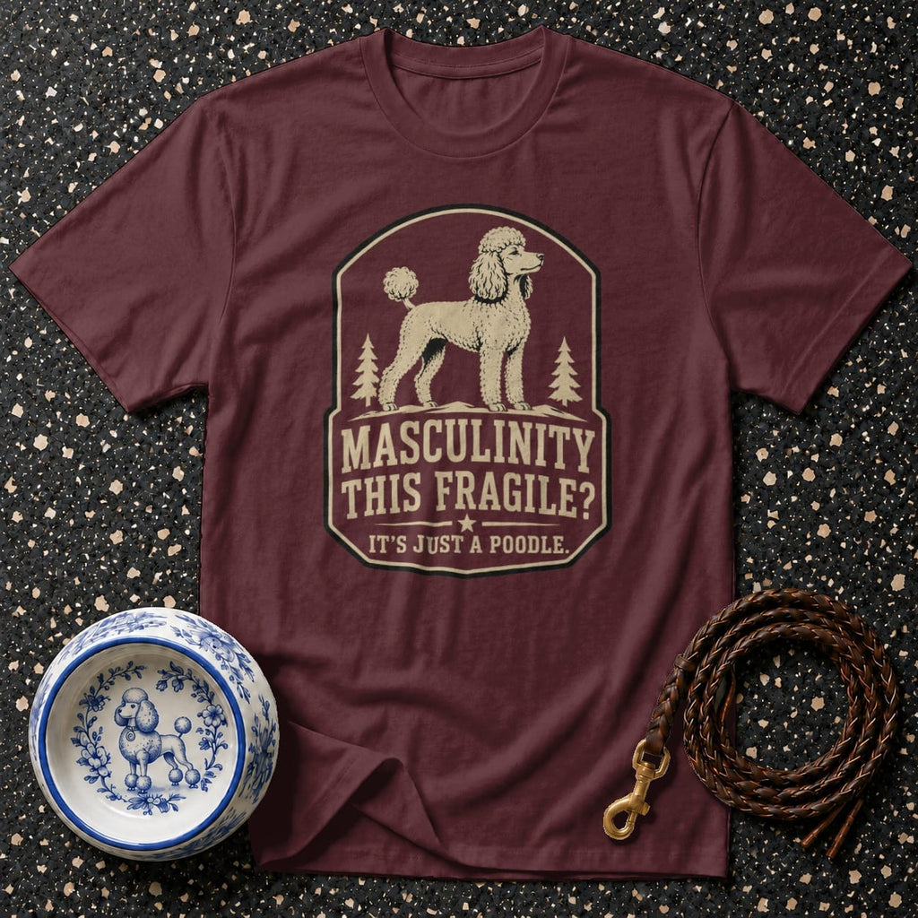 Burgundy t-shirt with poodle graphic and text "Masculinity This Fragile? It's Just a Poodle."