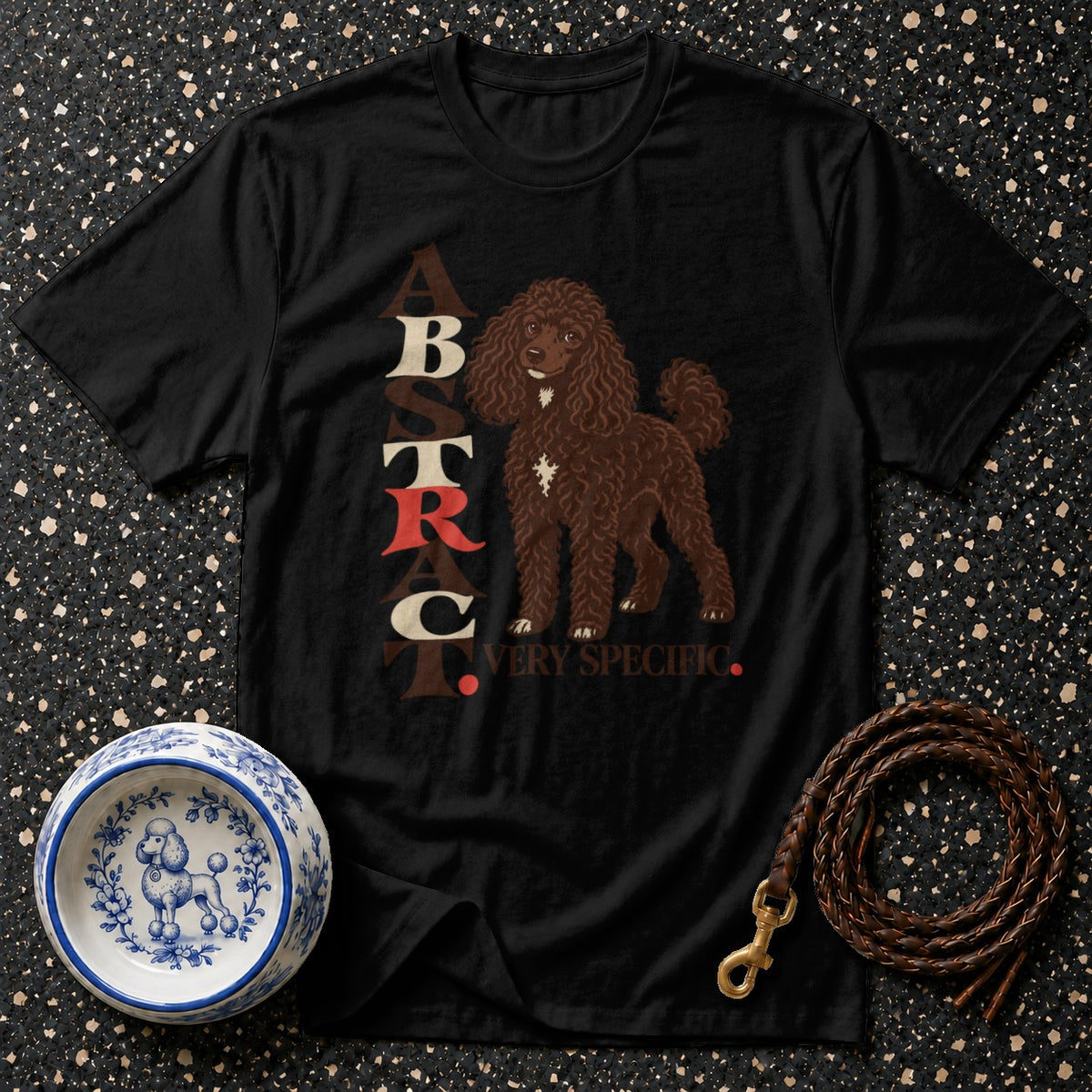 Black t-shirt with "ABSTRACT. VERY SPECIFIC." text and brown poodle graphic.
