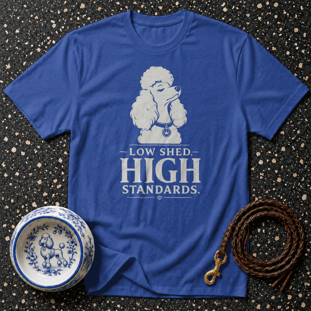 Blue t-shirt with white poodle graphic and text "LOW SHED. HIGH STANDARDS."