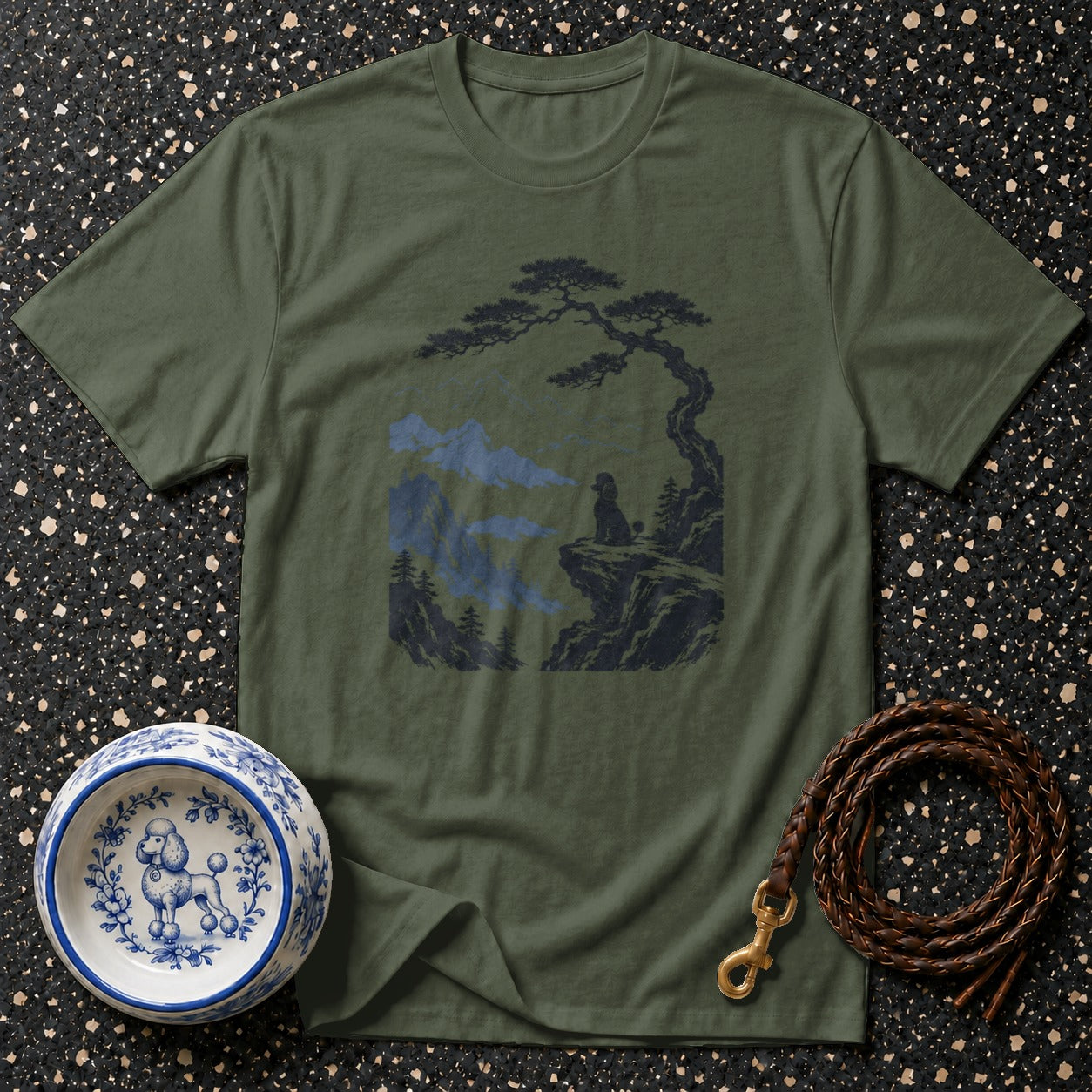 Olive green t-shirt with graphic of dog on cliff under bonsai tree.