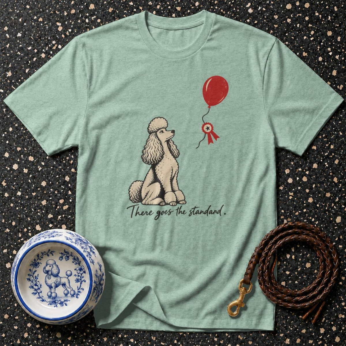 Light blue t-shirt with poodle and balloon graphic and text "There goes the standard."