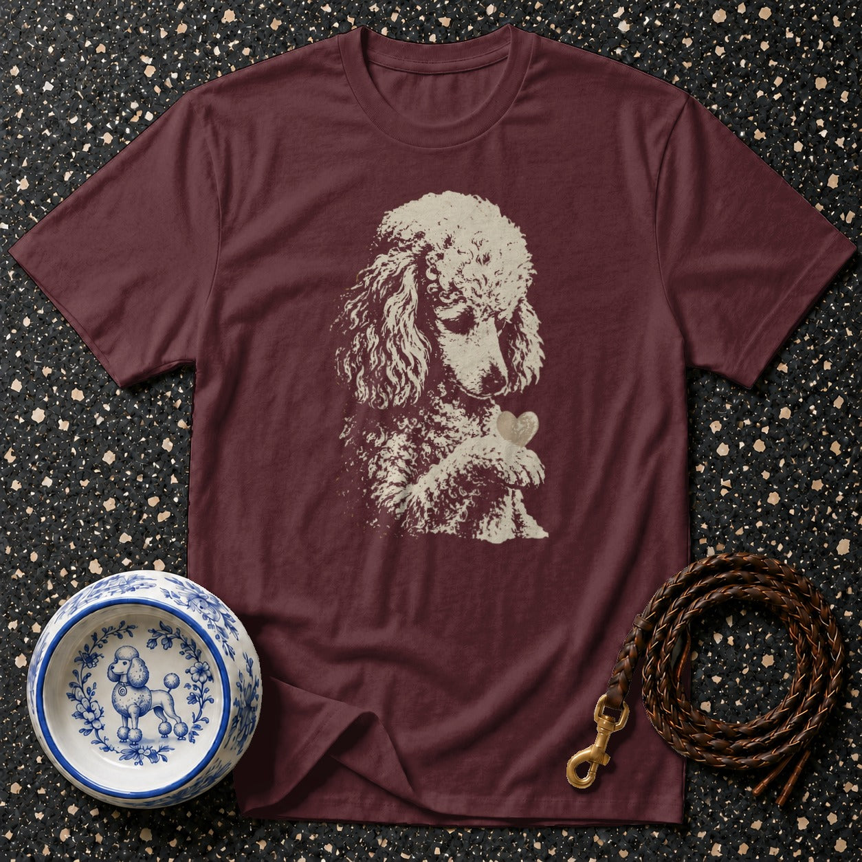 Maroon t-shirt with cream poodle graphic holding a heart; matching dog bowl and leash.