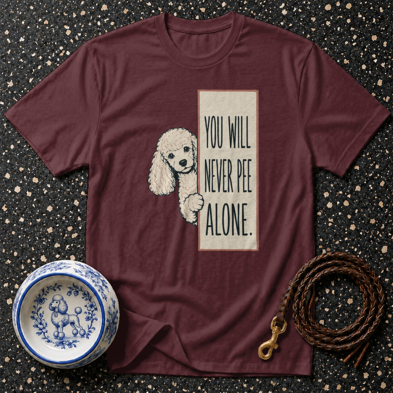 Maroon t-shirt with poodle graphic and text "You Will Never Pee Alone".