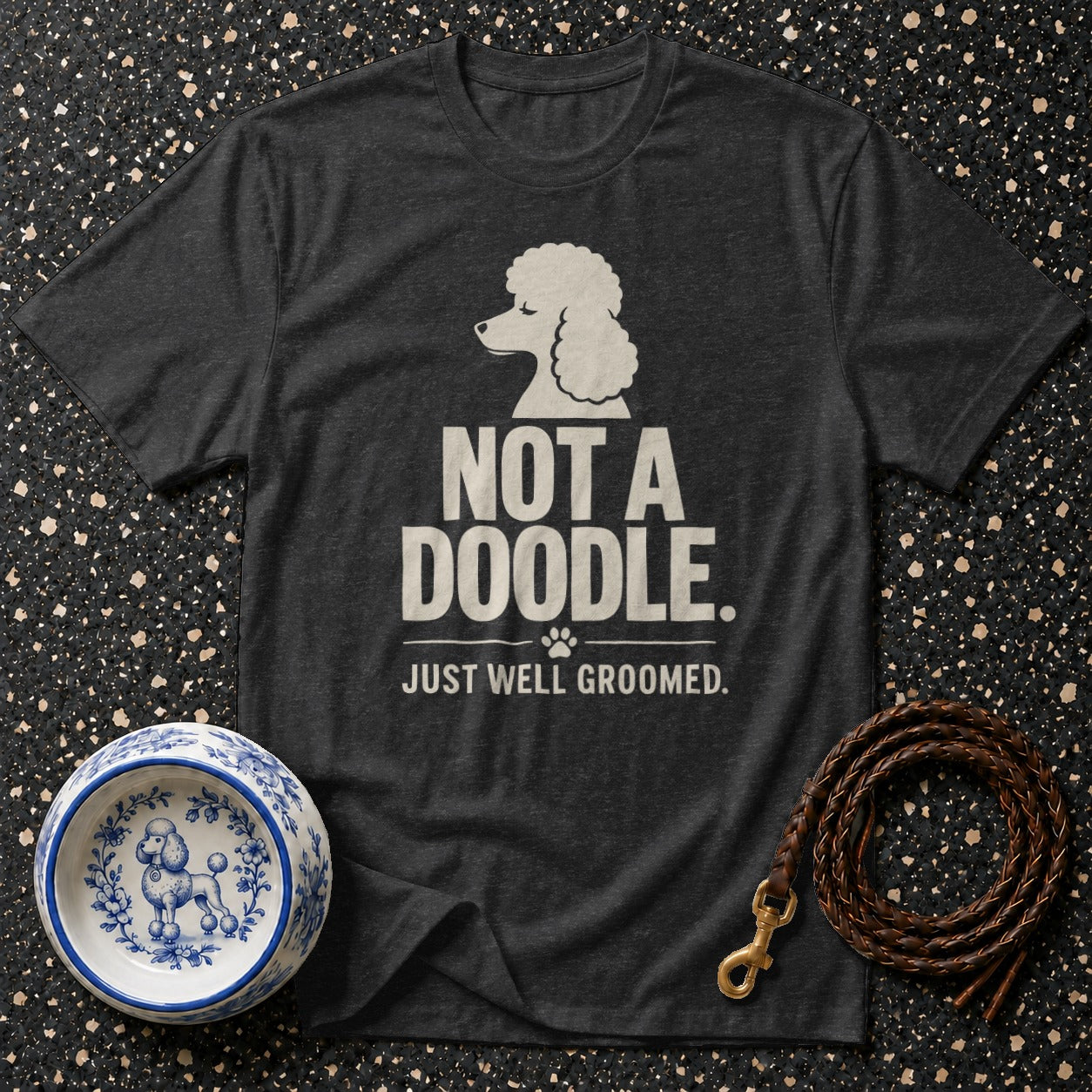 Dark gray t-shirt with white text "Not a Doodle. Just well groomed" and poodle graphic.