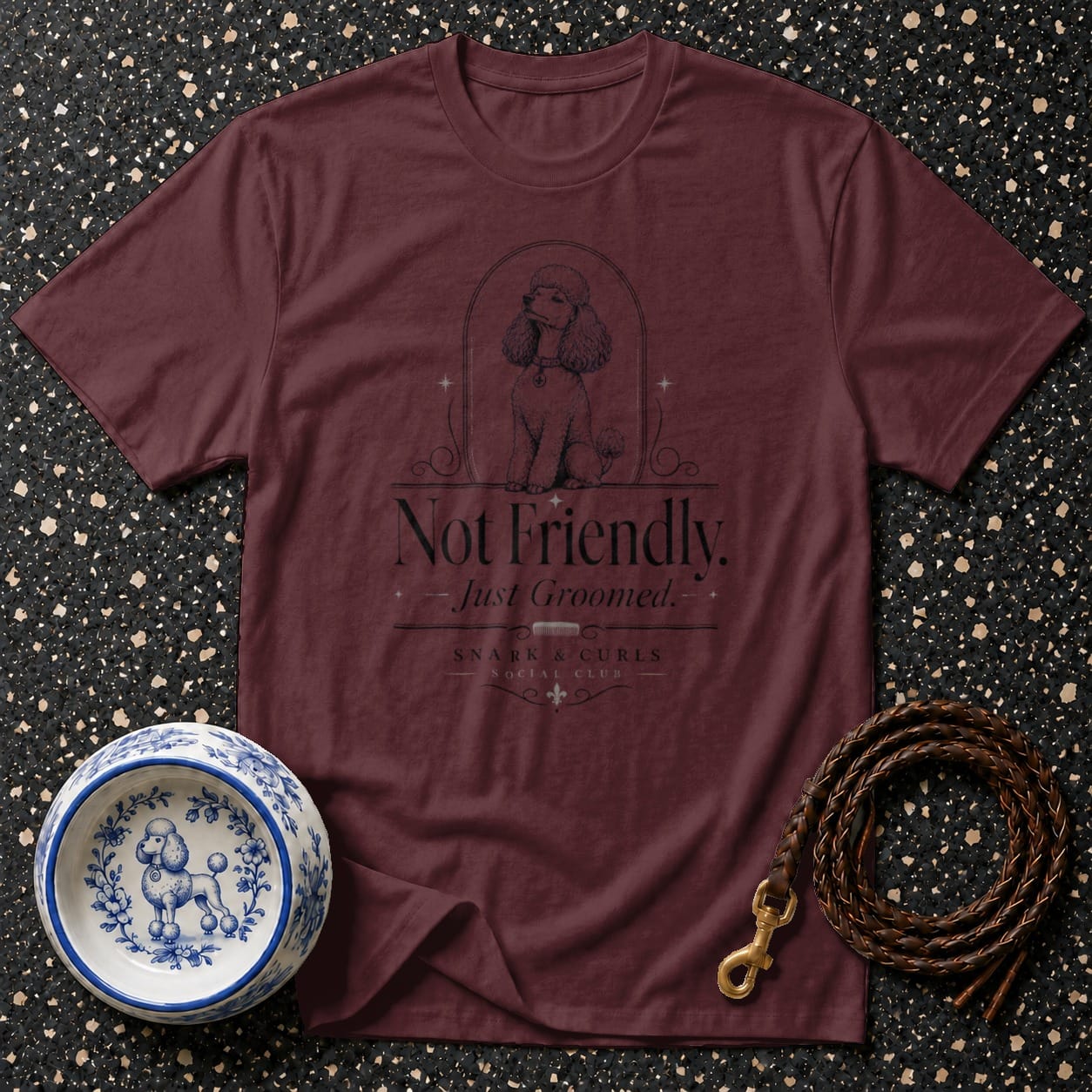 Burgundy t-shirt with black poodle graphic and text "Not Friendly. Just Groomed."