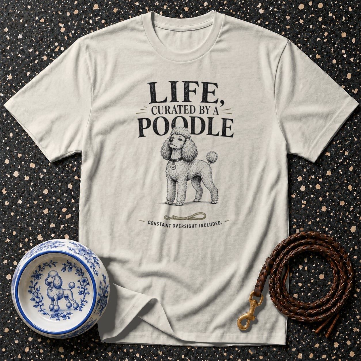 Cream t-shirt with text "LIFE, CURATED BY A POODLE" and a poodle illustration.