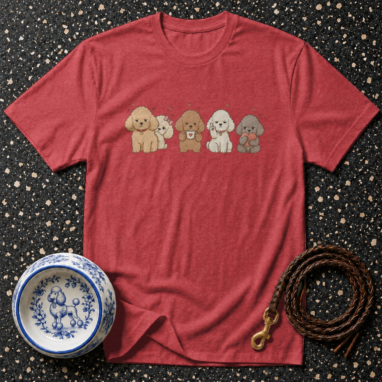 Red t-shirt with cartoon poodles, decorative dog bowl, and leather leash.