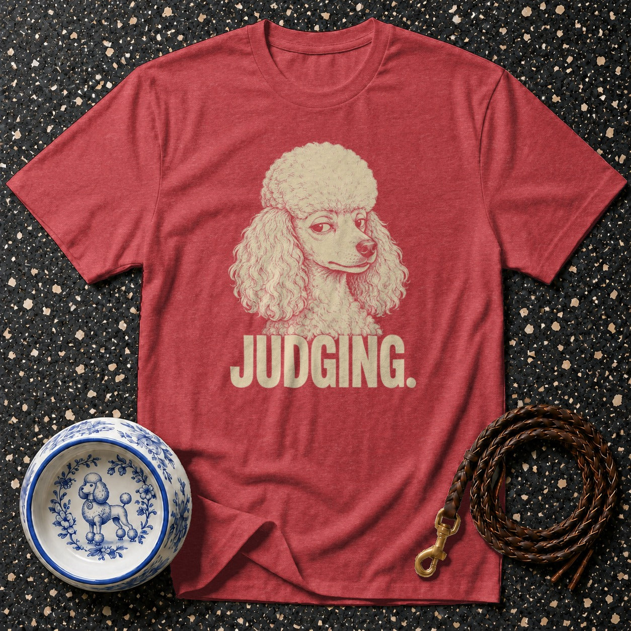 Red t-shirt with a poodle illustration and the text "JUDGING."