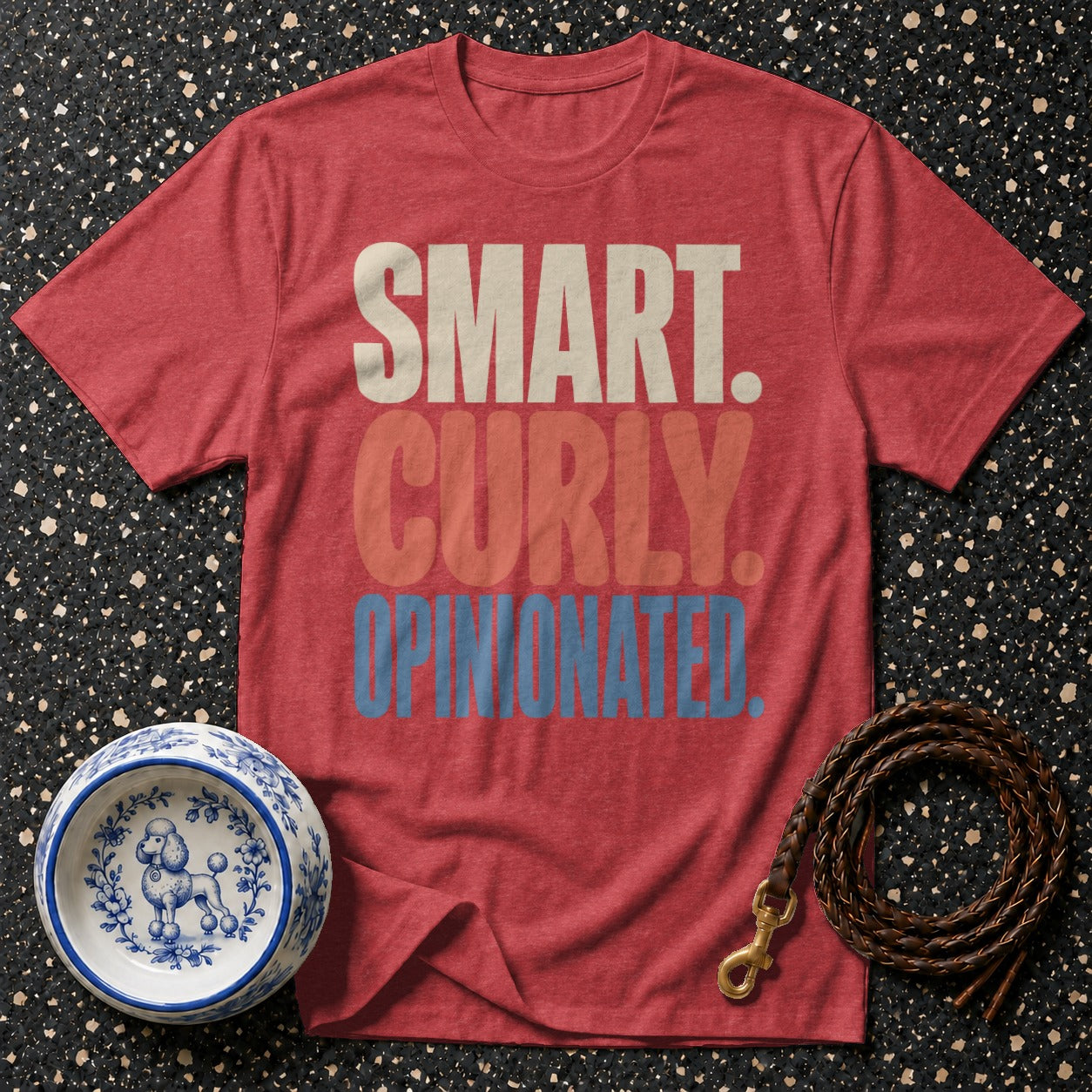 Red t-shirt with "SMART. CURLY. OPINIONATED." text, dog bowl, and leash.