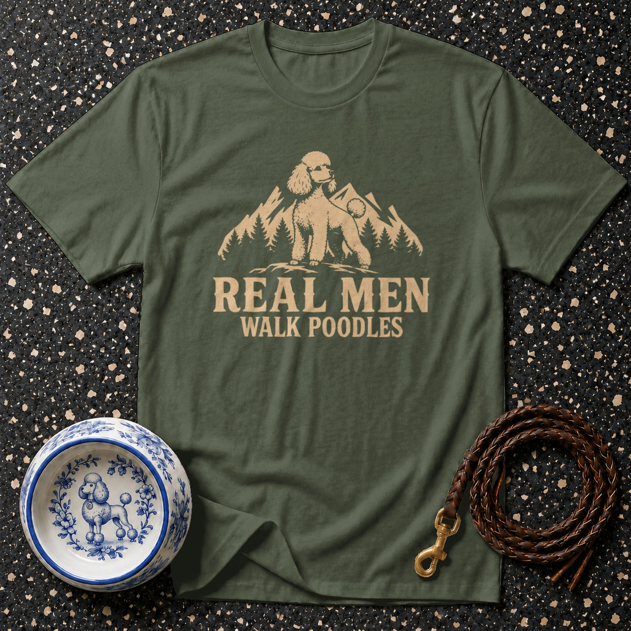 Green t-shirt with a graphic of a poodle, mountains, and the text "REAL MEN WALK POODLES".