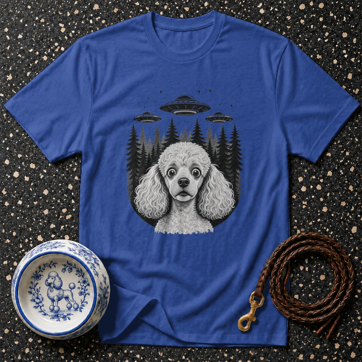 T-shirt with poodle, UFOs, and trees graphic design.