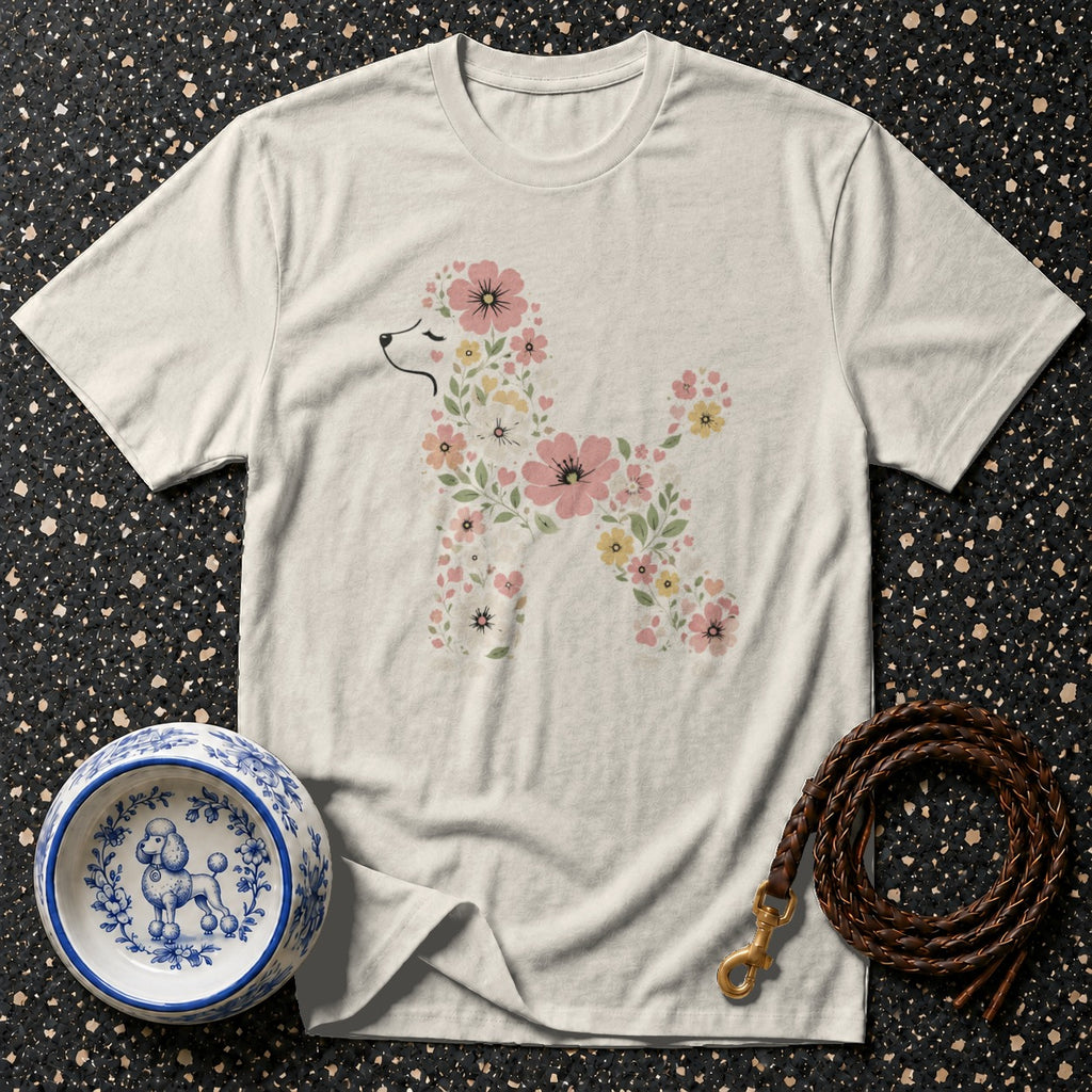 Light-colored t-shirt with a floral poodle graphic, dog bowl, and leather leash.