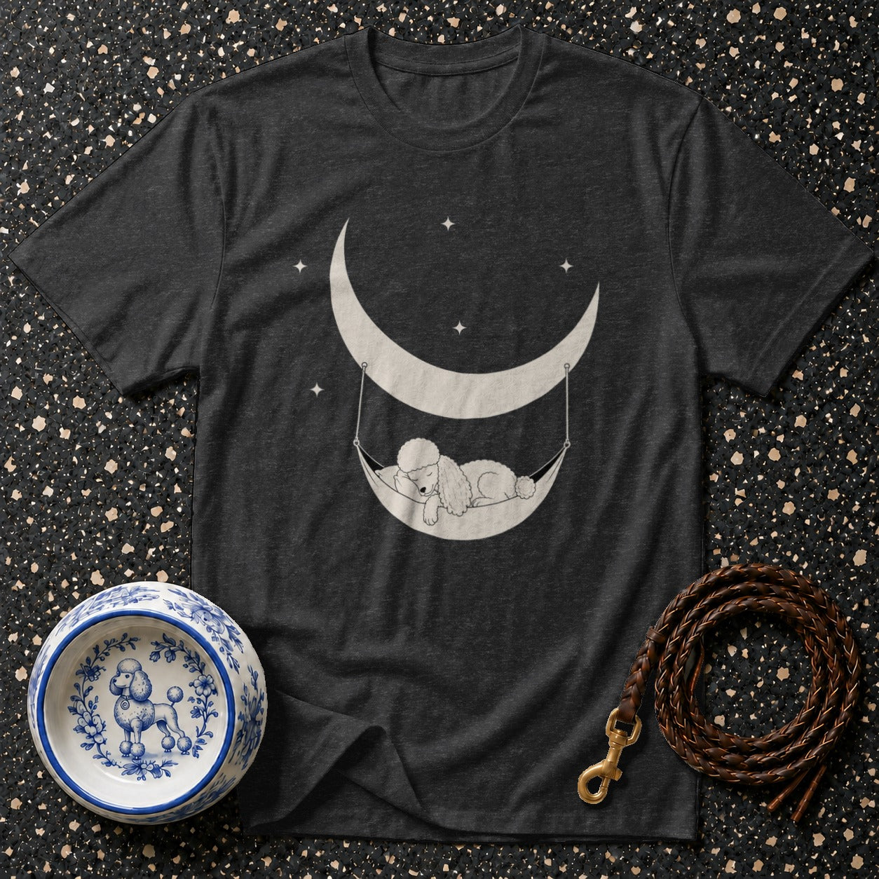 Dark grey t-shirt with white graphic of poodle sleeping in a hammock on a crescent moon.