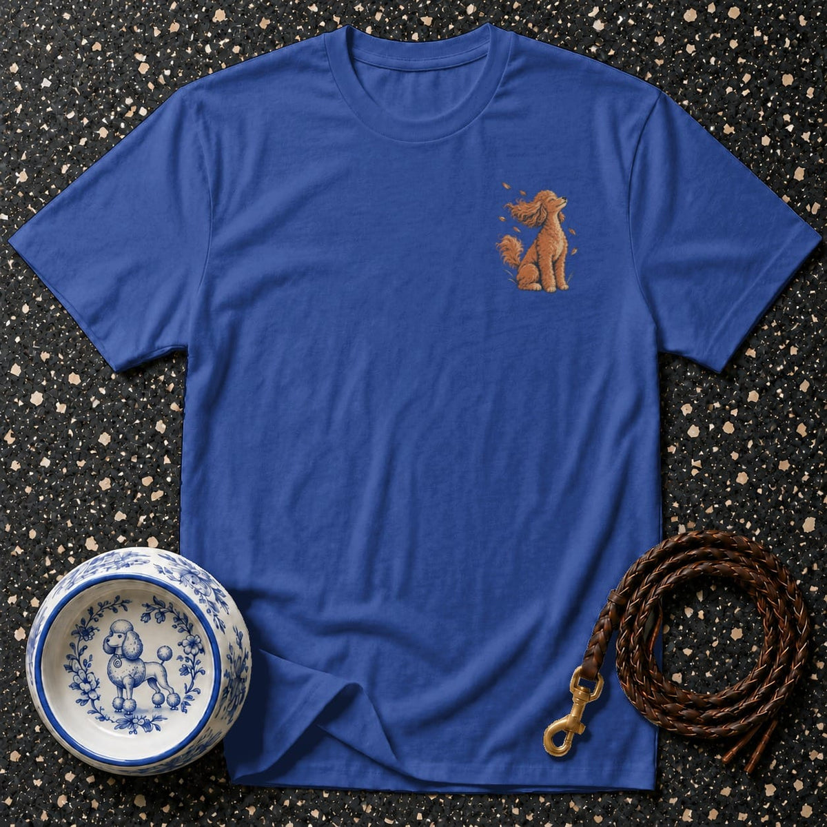 Blue t-shirt with brown poodle graphic and dog bowl and leash accessories.