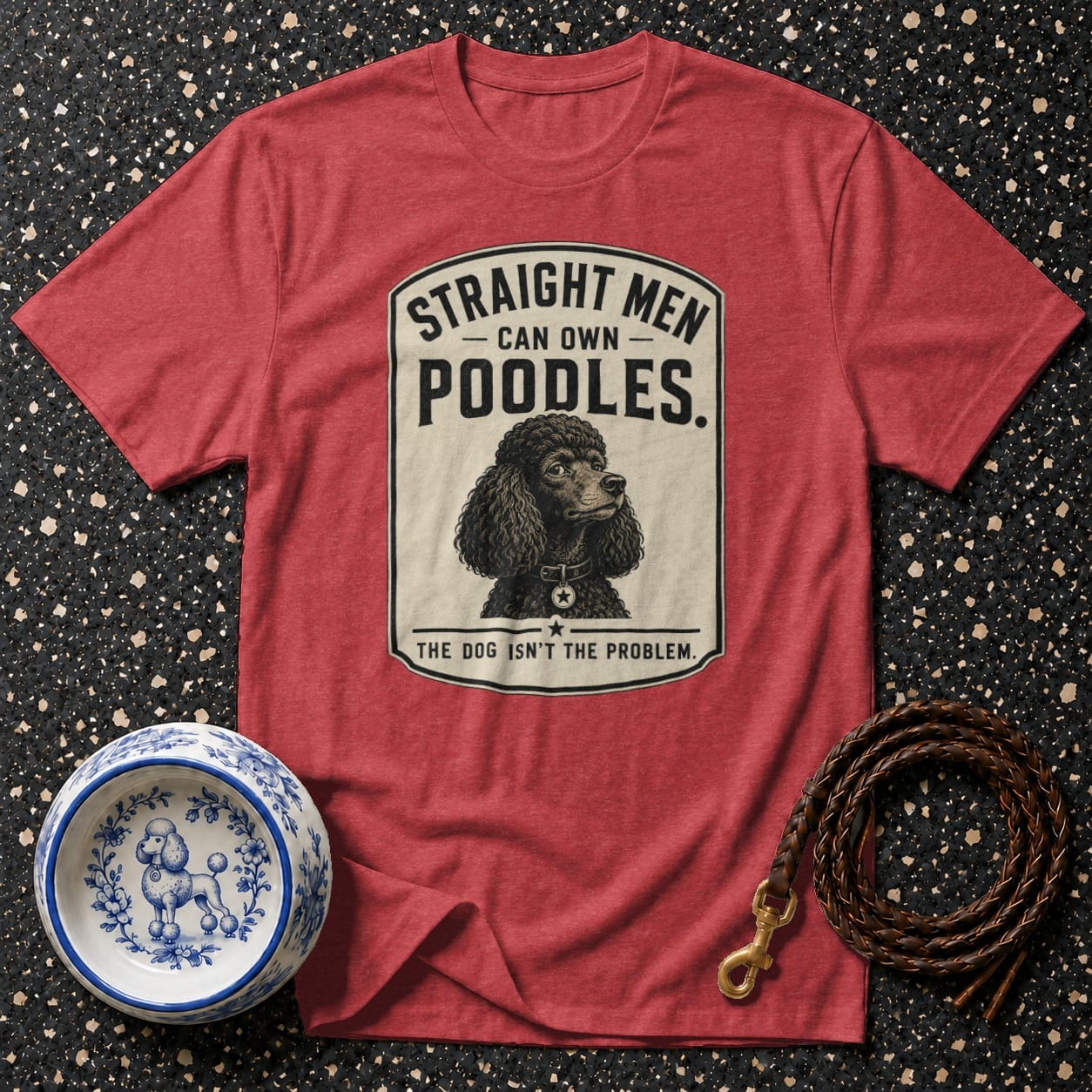 Red t-shirt with a graphic of a poodle and text: "Straight Men Can Own Poodles. The Dog Isn't The Problem."