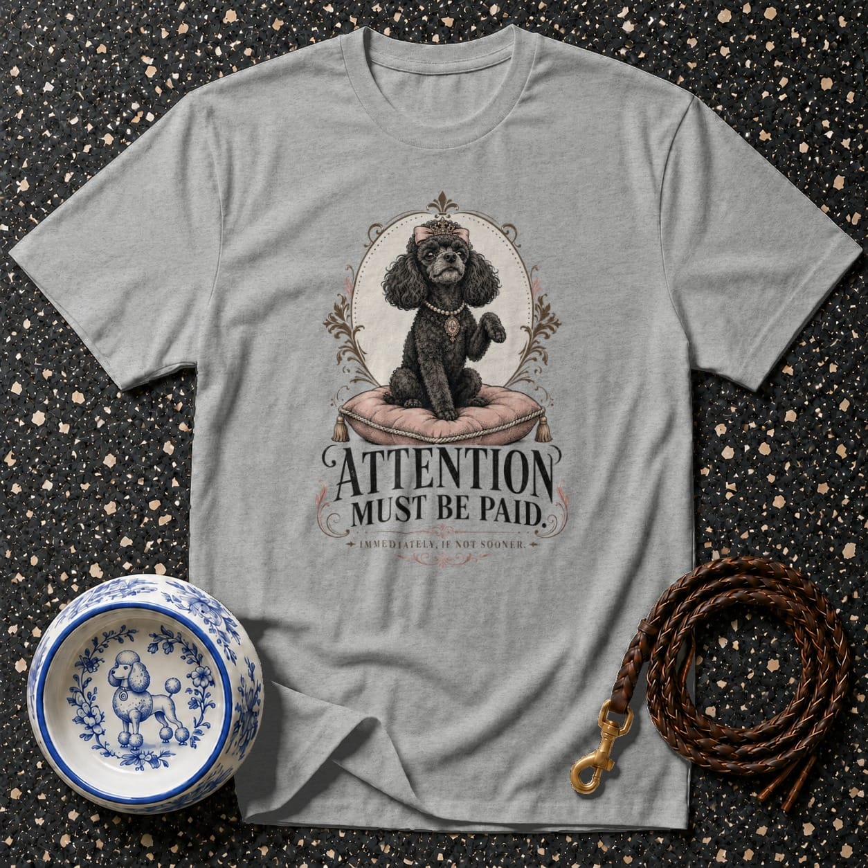 Grey t-shirt with a black poodle wearing a crown and "Attention Must Be Paid" text.