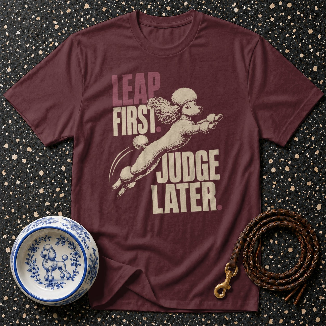 Maroon t-shirt with poodle graphic and text "LEAP FIRST JUDGE LATER".