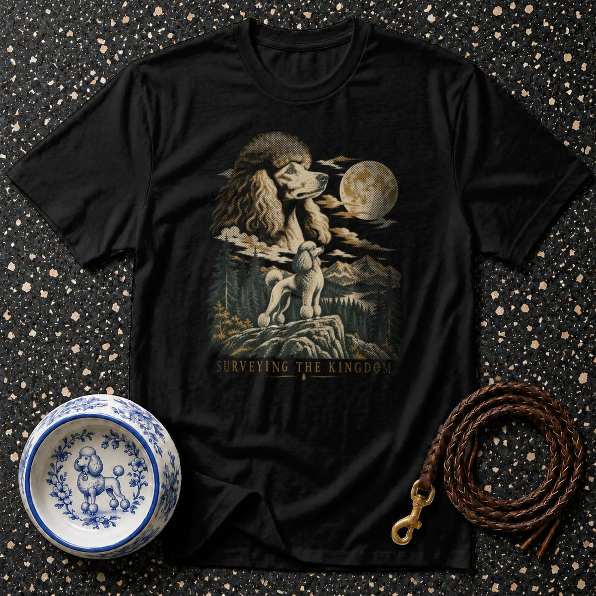 Black t-shirt with poodles surveying a moonlit mountain landscape with text "SURVEYING THE KINGDOM".