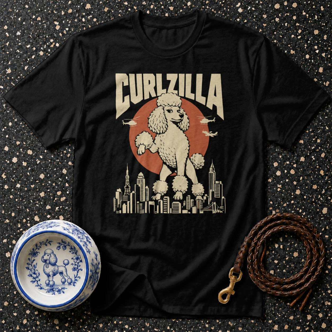 Black t-shirt with "CURLZILLA" text and a poodle over a city skyline.
