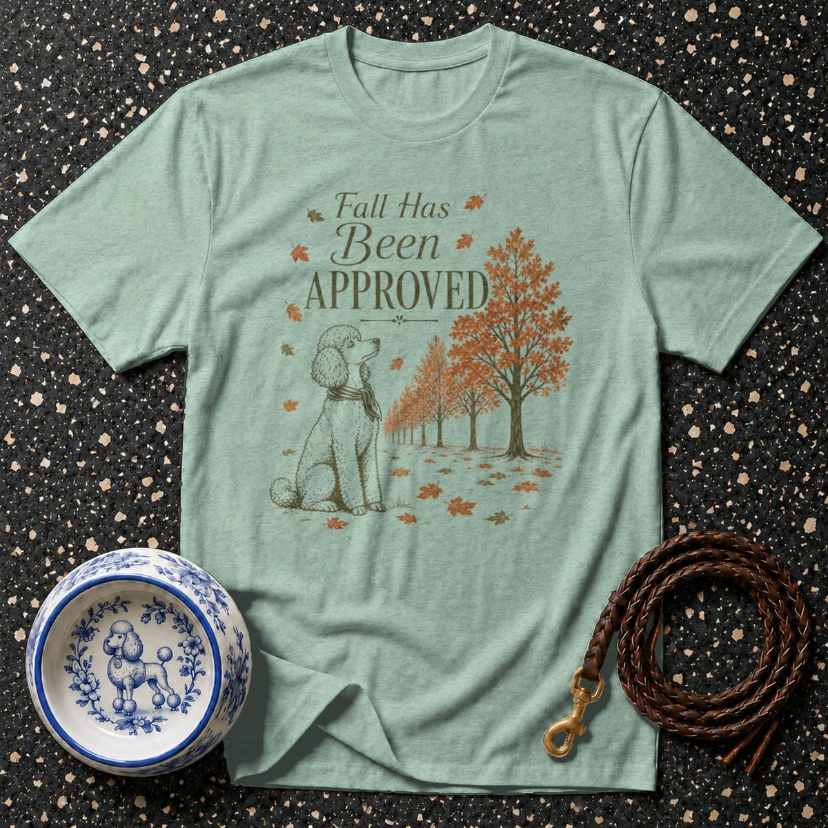 Light green t-shirt with text "Fall Has Been Approved," a poodle, and autumn trees.