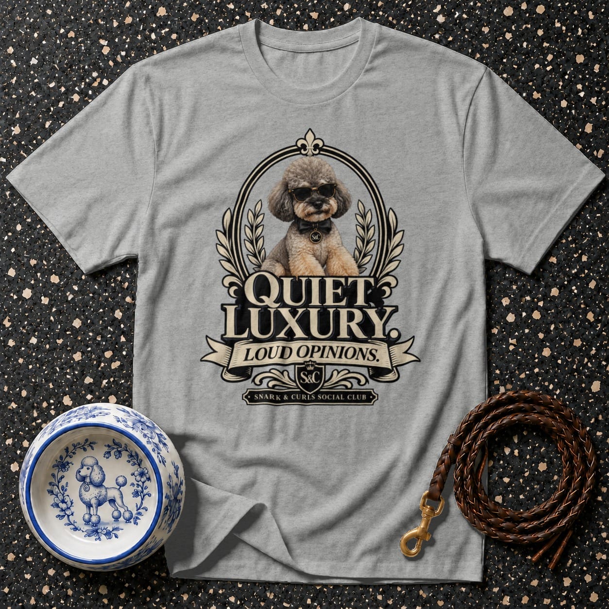 Grey t-shirt with a poodle wearing sunglasses and a bow tie above "QUIET LUXURY LOUD OPINIONS."