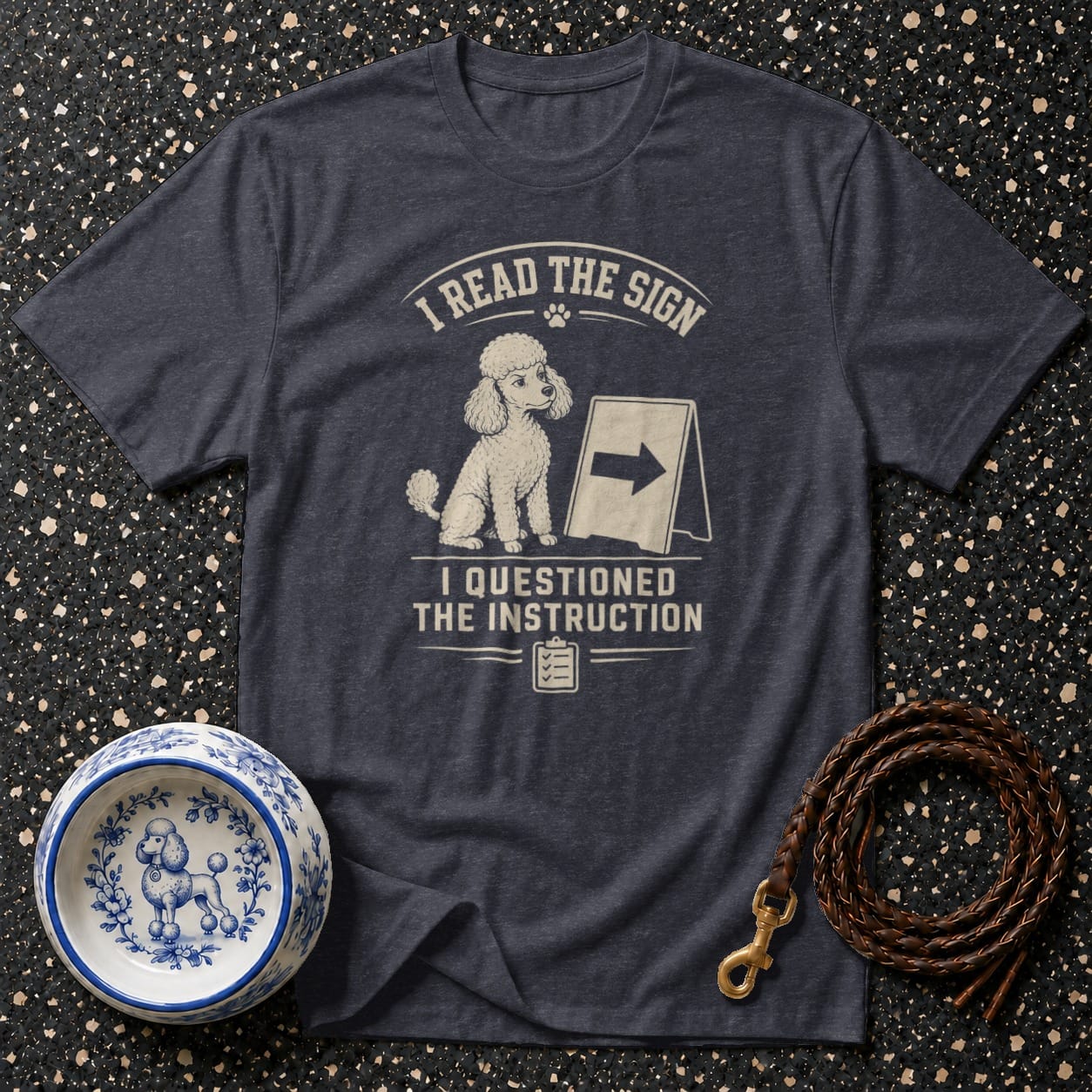 Dark grey t-shirt with white text and a poodle illustration: "I READ THE SIGN I QUESTIONED THE INSTRUCTION."