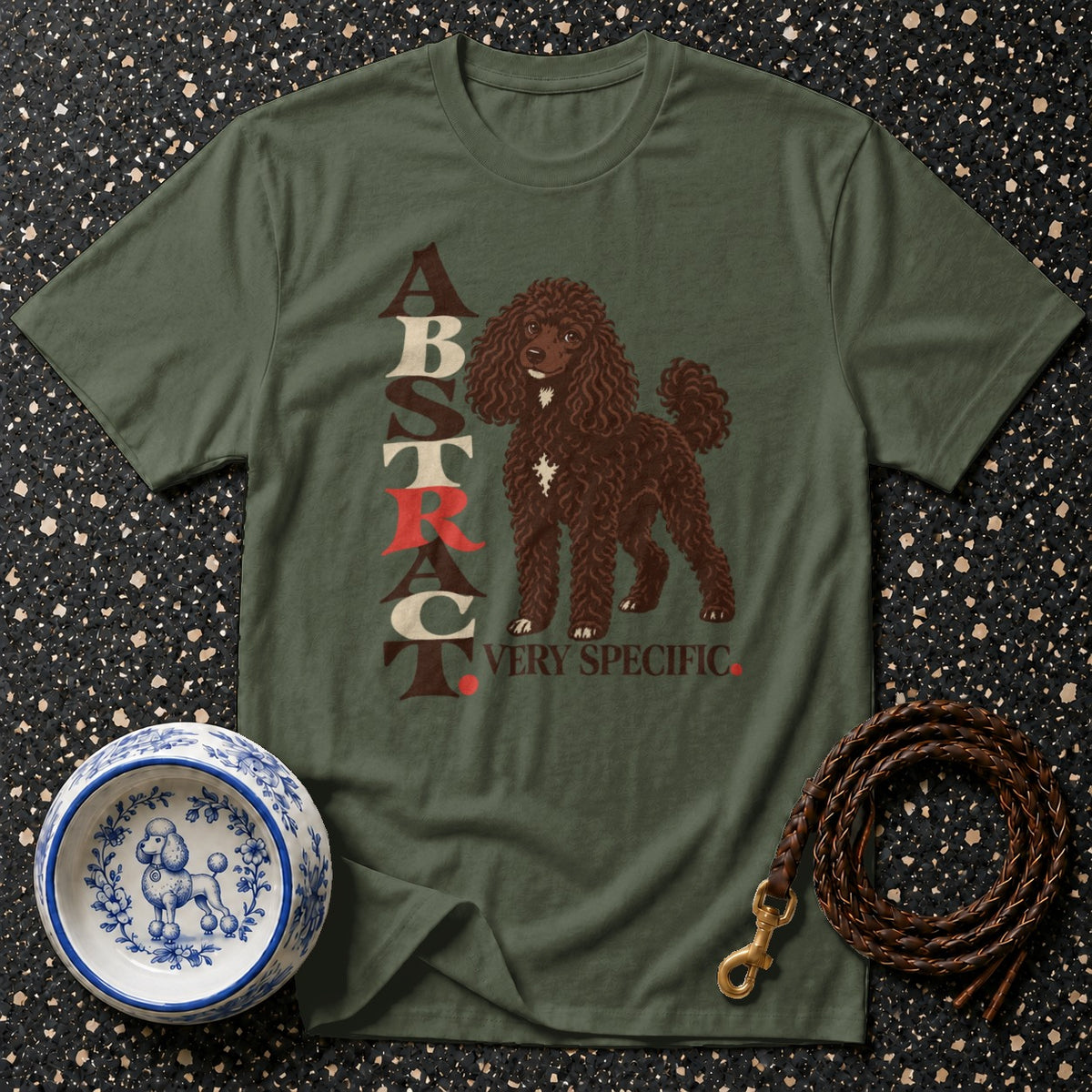 Green t-shirt with brown poodle graphic and "ABSTRACT VERY SPECIFIC" text.