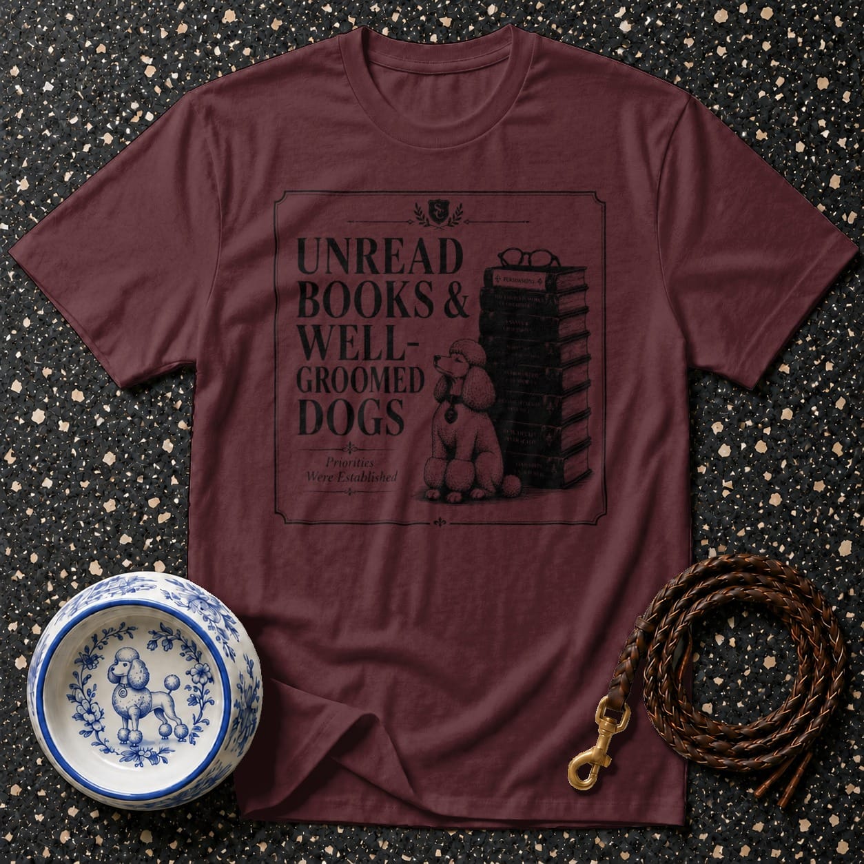 Maroon t-shirt with text "Unread Books & Well-Groomed Dogs".