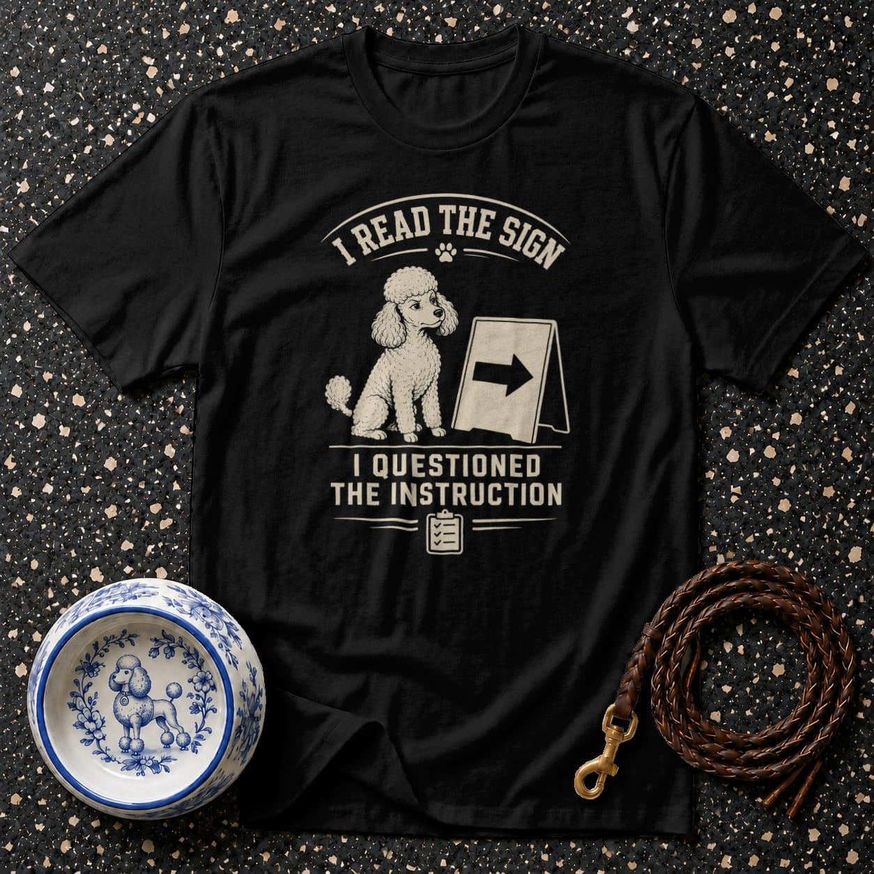 Black t-shirt with poodle design and text "I read the sign. I questioned the instruction."