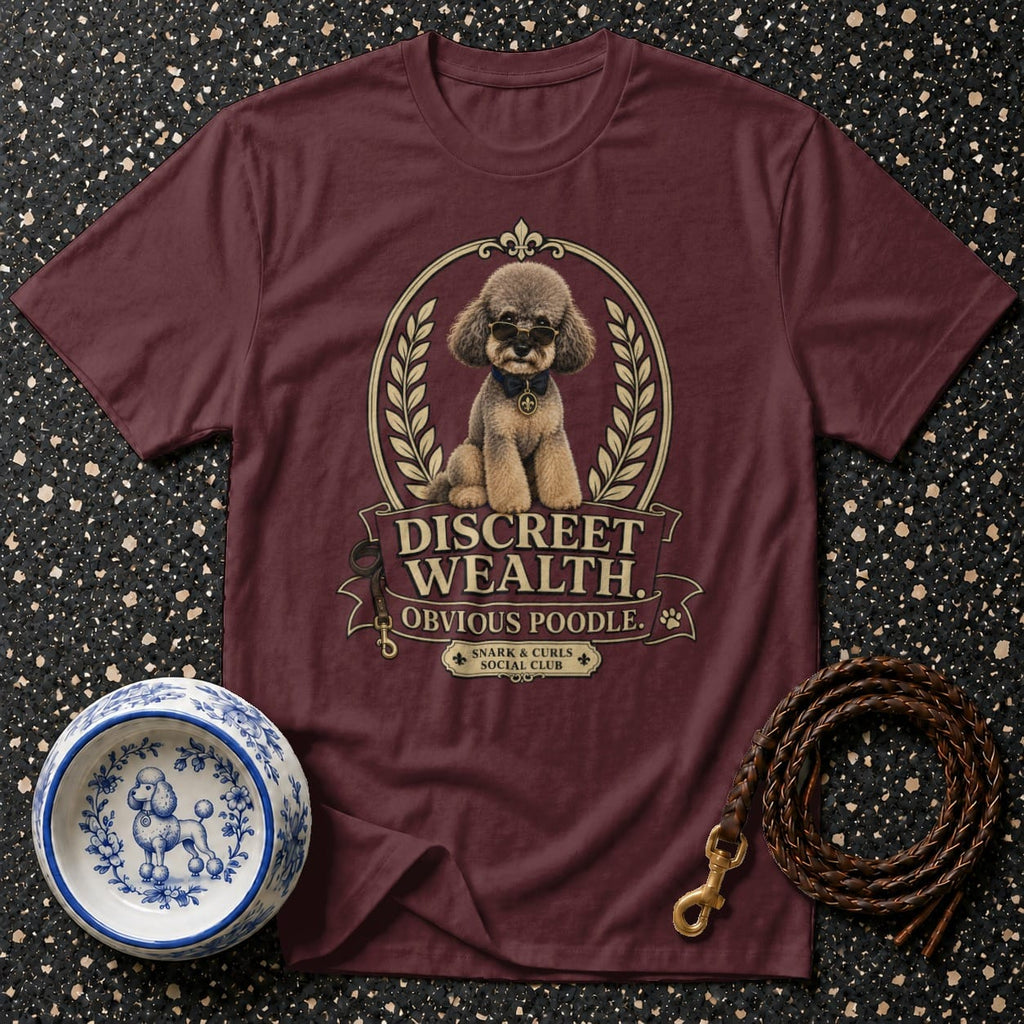 Maroon t-shirt with a poodle graphic, sunglasses, and text: "Discreet Wealth Obvious Poodle. Snark & Curls Social Club."