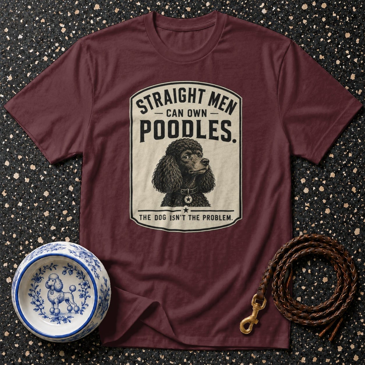 Maroon t-shirt with "Straight Men Can Own Poodles. The Dog Isn't The Problem." slogan and poodle illustration.