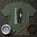 Olive green t-shirt with a black poodle illustration and "TUXEDO. BUILT IN." text.