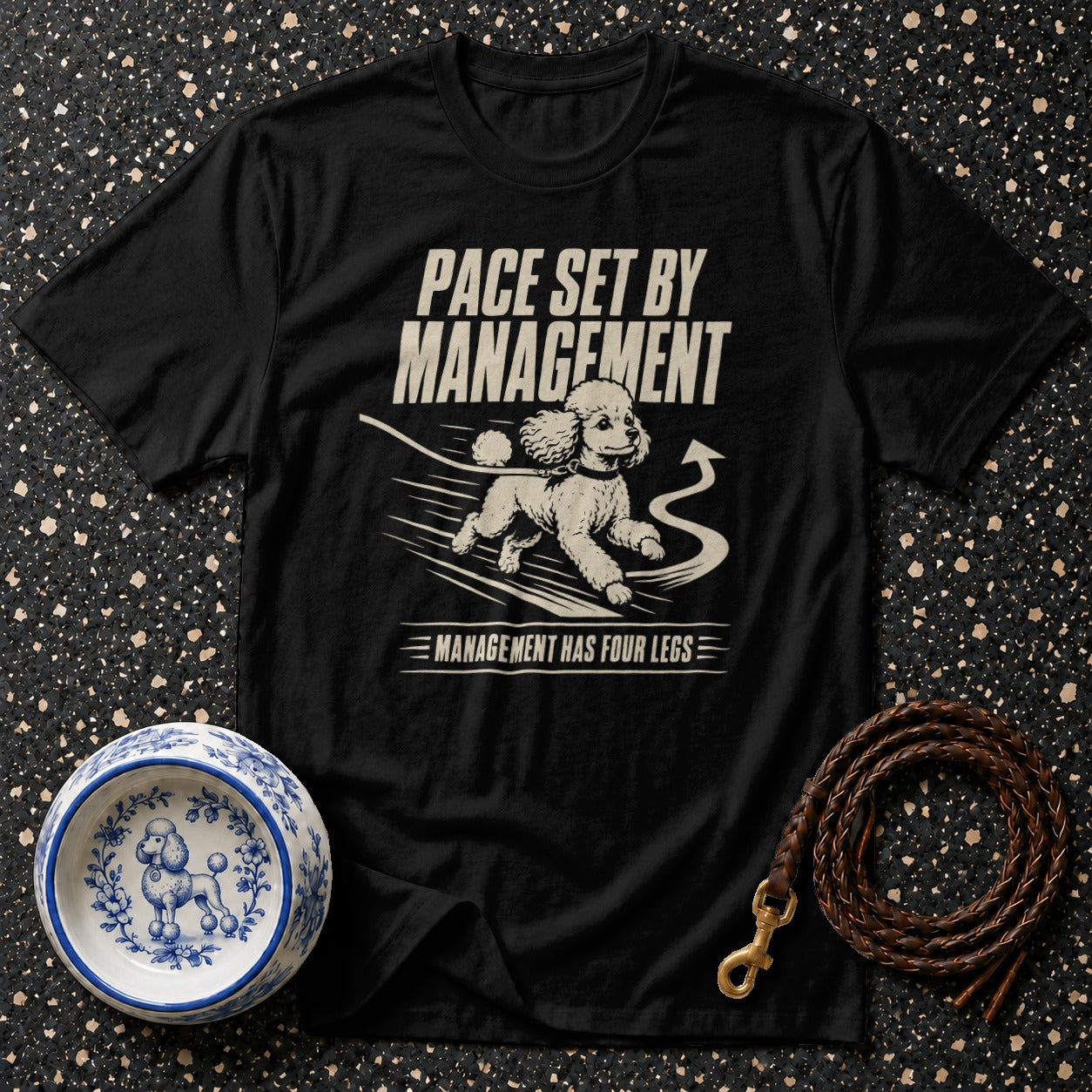 Black t-shirt with a poodle graphic and text "Pace set by management. Management has four legs."