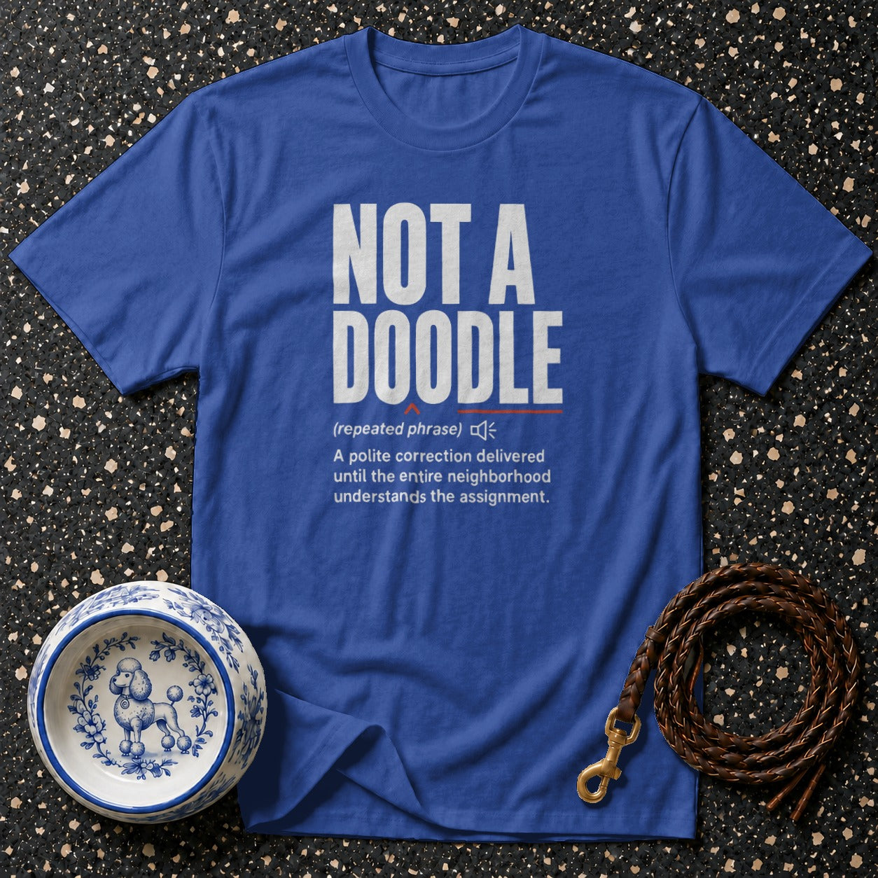 Blue t-shirt with "NOT A DOODLE" definition relating to pet correction.