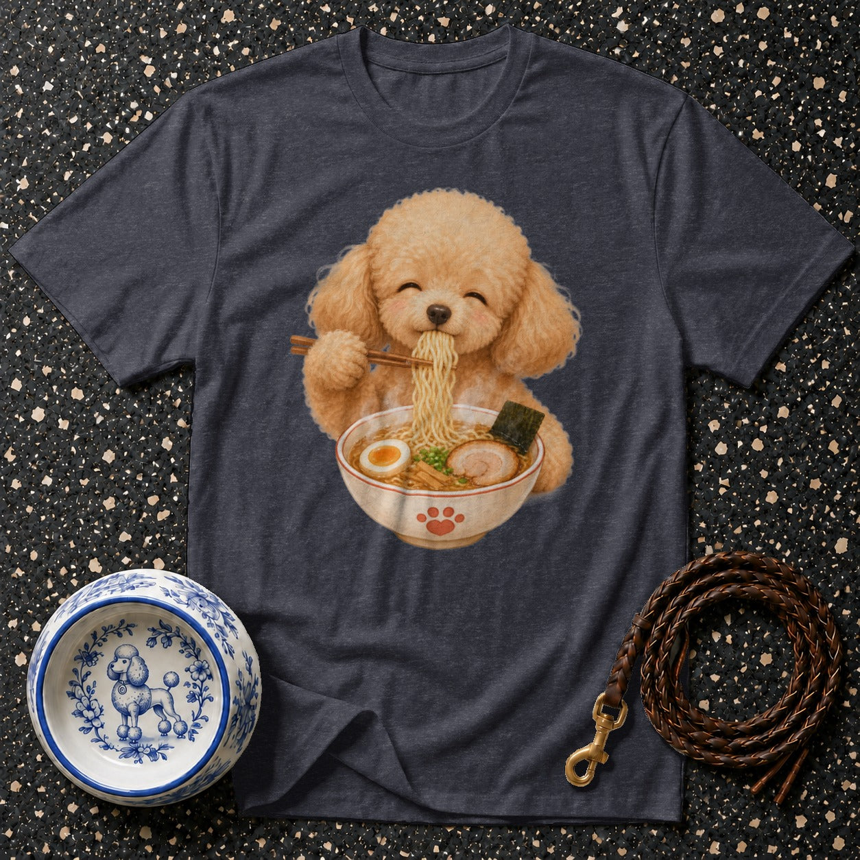 Poodle eating ramen noodles with chopsticks on a dark t-shirt.