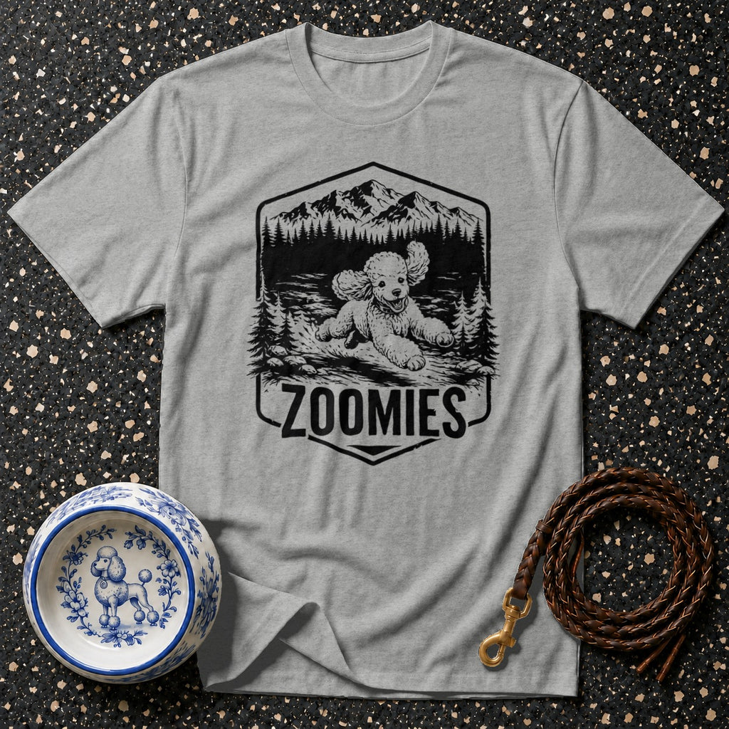 Grey t-shirt with black graphic of a poodle running in a forest scene, text "ZOOMIES".