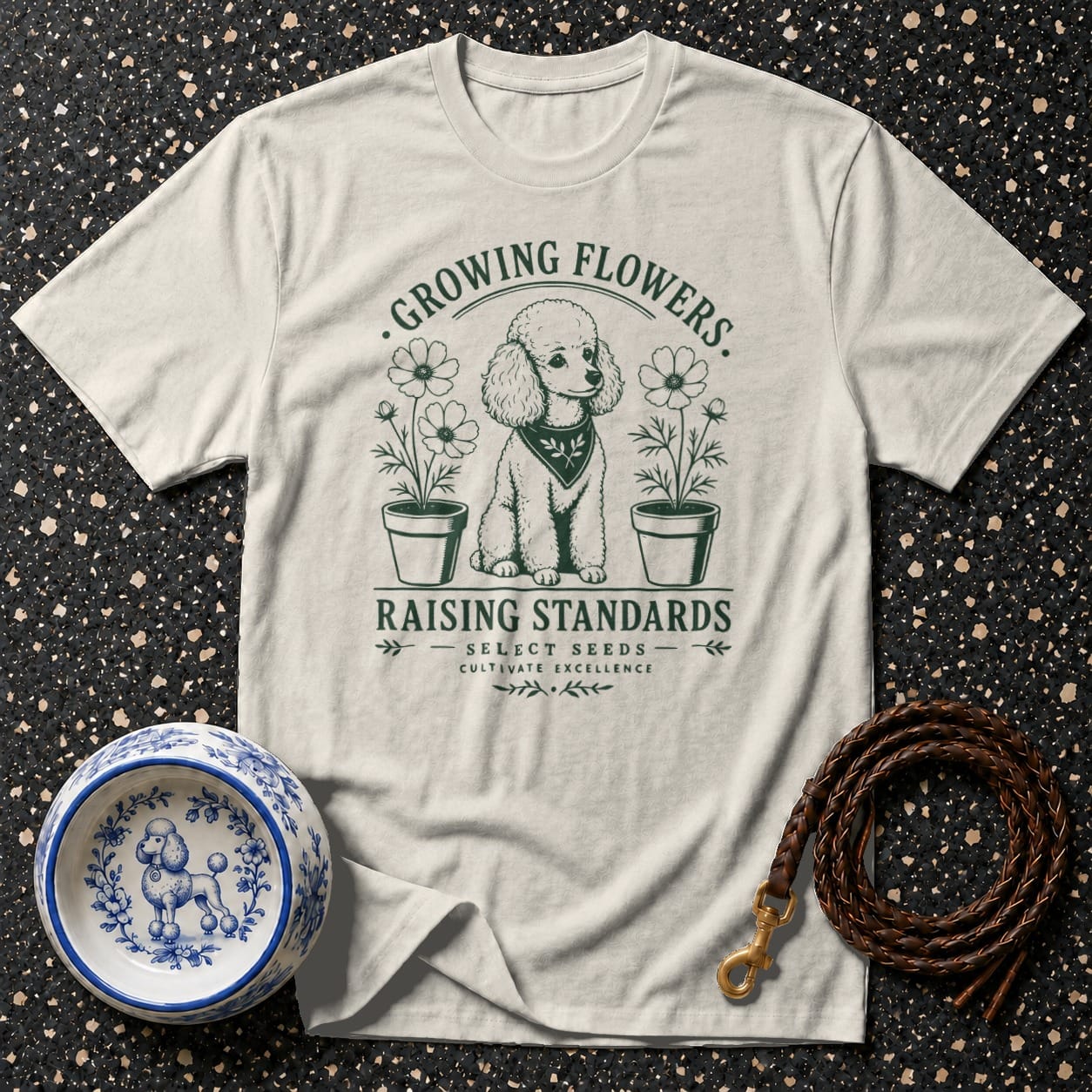 T-shirt with poodle illustration, "Growing Flowers. Raising Standards." text, and dog accessories.