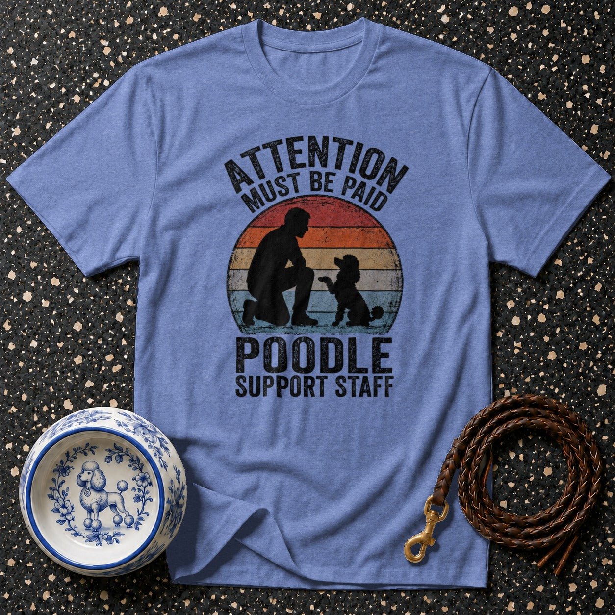 Blue t-shirt with graphic: "ATTENTION MUST BE PAID POODLE SUPPORT STAFF"