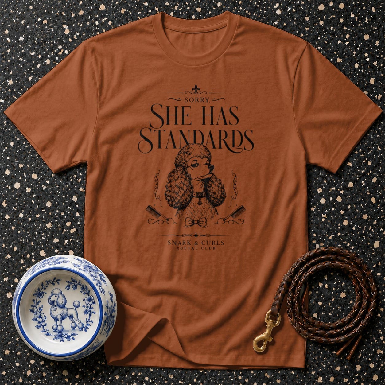 Orange t-shirt with "Sorry, She Has Standards" poodle graphic and "Snark & Curls Social Club".