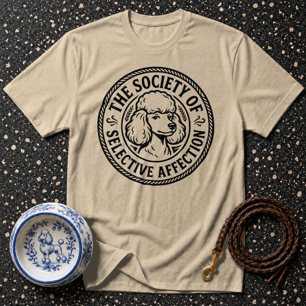 Tan t-shirt with a circular black design featuring a poodle head and text.