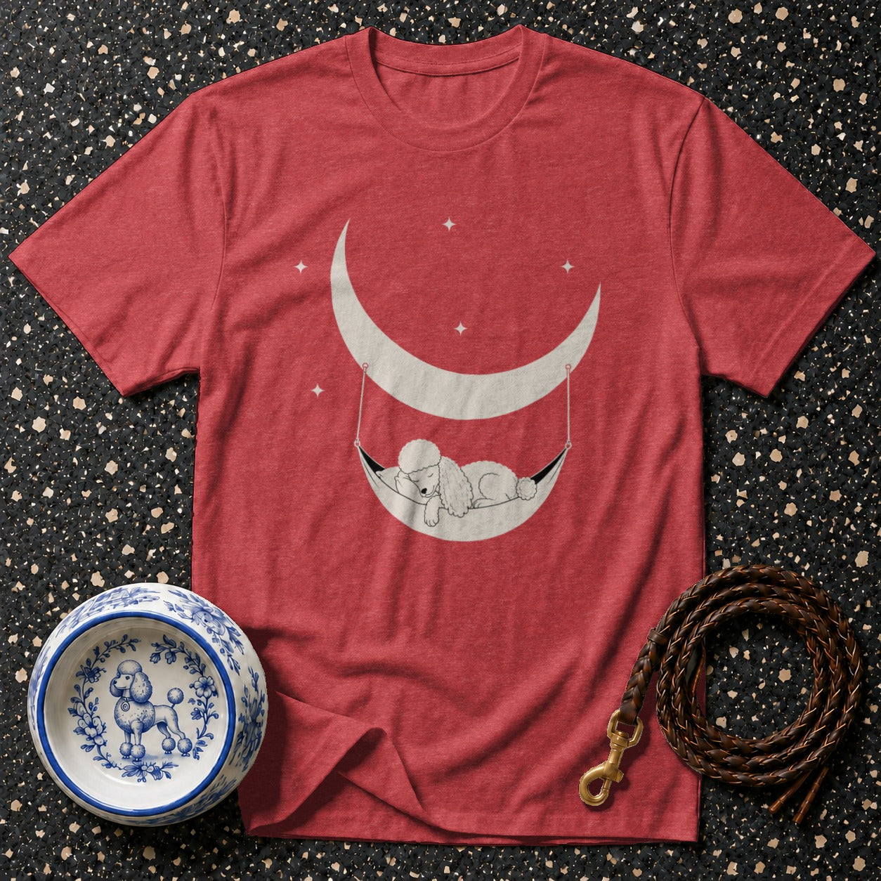 Red t-shirt with sleeping poodle in moon hammock design and decorative dog bowl.