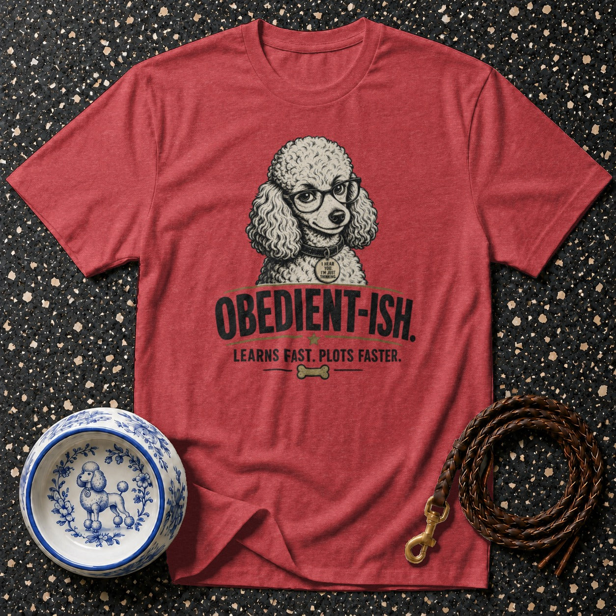 Red t-shirt with a poodle wearing glasses and the text "OBEDIENT-ISH. LEARNS FAST. PLOTS FASTER."
