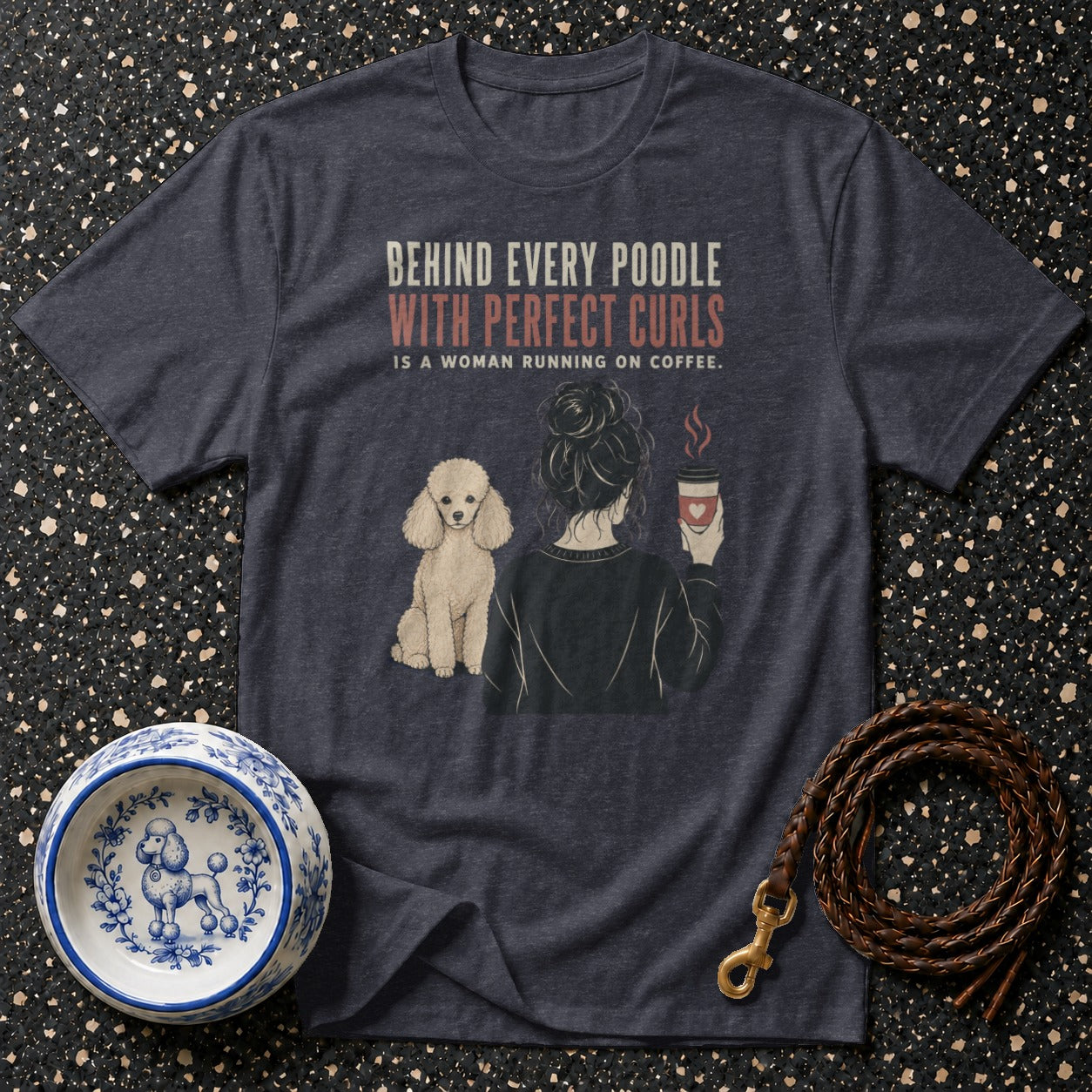 Dark grey t-shirt with "Behind every poodle with perfect curls is a woman running on coffee" text.